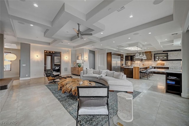 tiled living room featuring ceiling fan, coffered ceiling, and beam ceiling