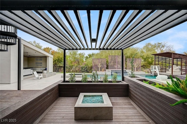 deck with a pool with hot tub, a fire pit, and a pergola