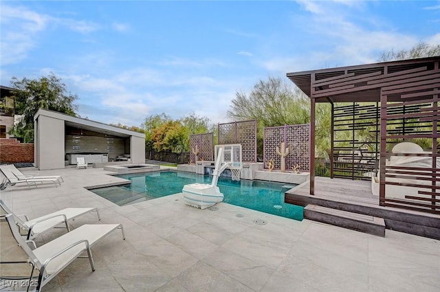 view of pool featuring exterior kitchen, a patio, and a jacuzzi