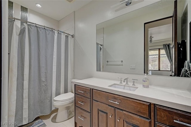 bathroom with tile patterned flooring, vanity, and toilet