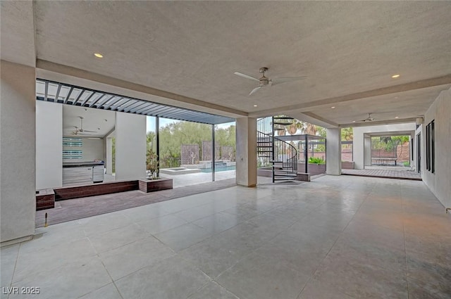 view of patio / terrace featuring ceiling fan and a swimming pool with hot tub