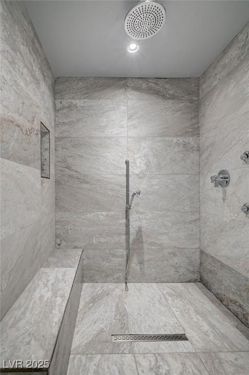 bathroom with a tile shower