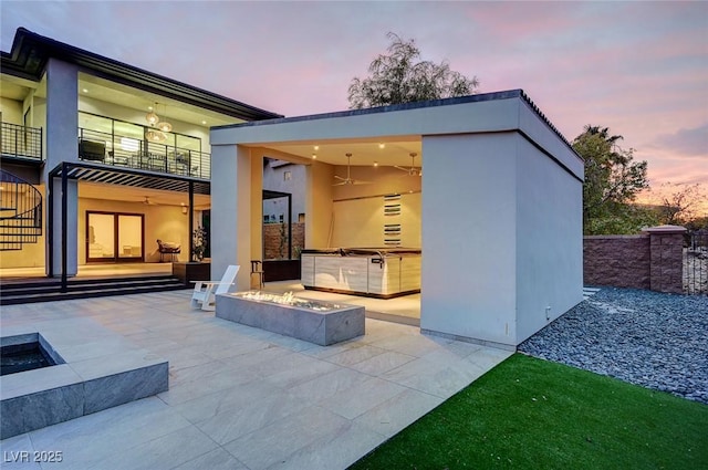 exterior space with area for grilling and a fire pit