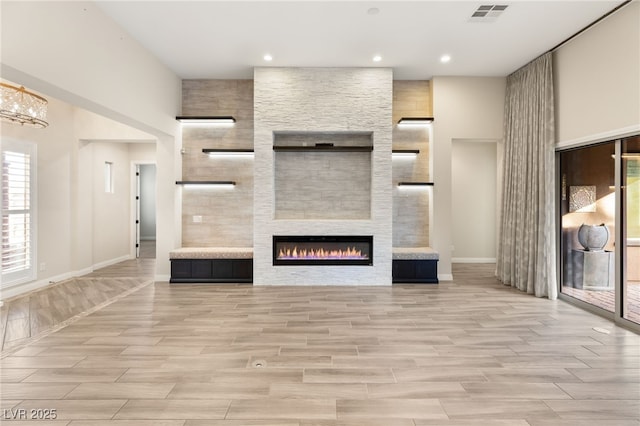 unfurnished living room featuring a large fireplace