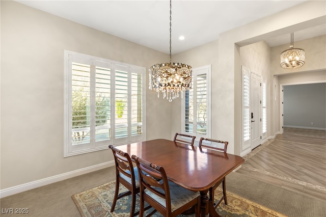 dining space with an inviting chandelier