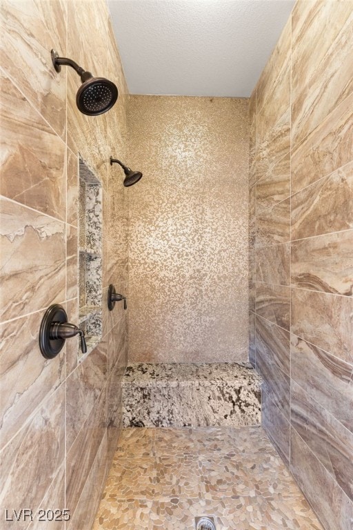 bathroom with tiled shower