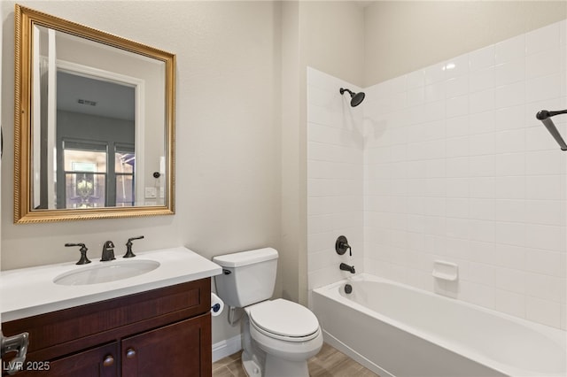 full bathroom with vanity, toilet, and tiled shower / bath combo