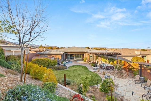 rear view of house featuring a patio area and a lawn