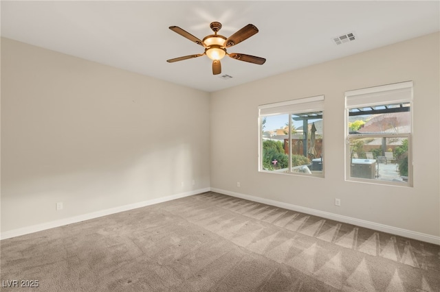 spare room featuring carpet floors and ceiling fan