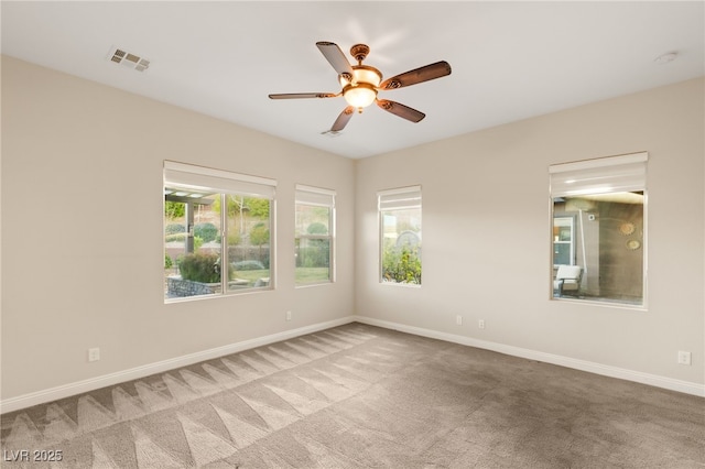 empty room featuring light carpet and ceiling fan