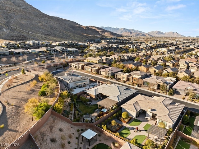 birds eye view of property with a mountain view