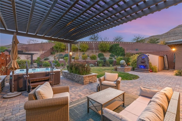 patio terrace at dusk with an outdoor living space, a hot tub, and a pergola