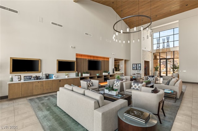 living room featuring wood ceiling, a chandelier, and high vaulted ceiling