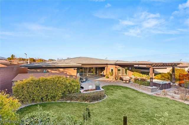 rear view of property featuring a patio and a lawn