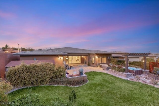 back house at dusk with a patio, a yard, an outdoor hangout area, and a pergola