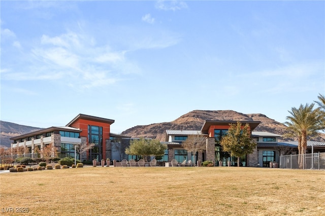 view of property's community featuring a mountain view and a lawn