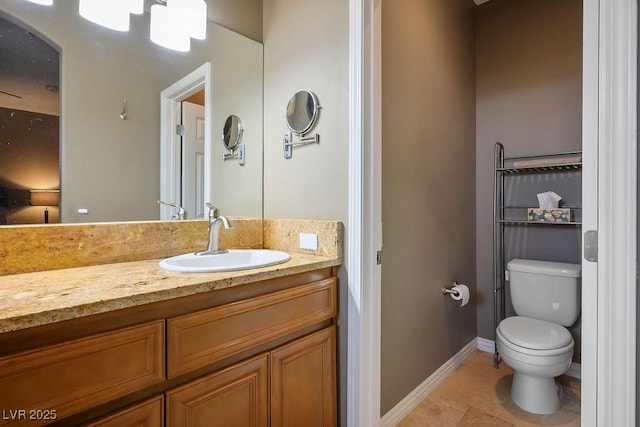 bathroom featuring vanity, tile patterned floors, and toilet