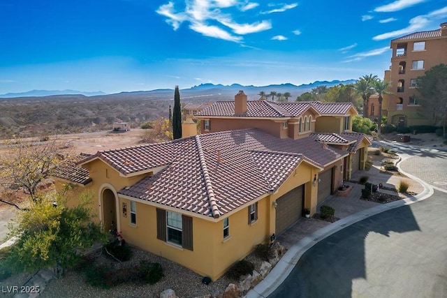 birds eye view of property with a mountain view