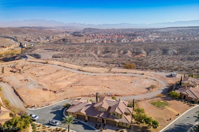 birds eye view of property featuring a mountain view