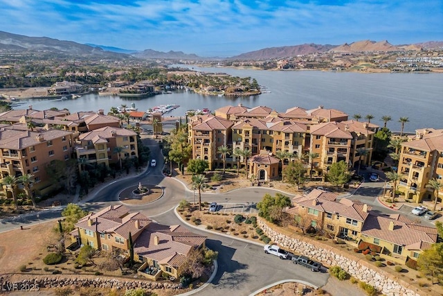 drone / aerial view featuring a water and mountain view