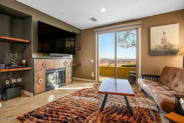 living room with a tile fireplace