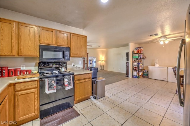 kitchen with light tile patterned floors, ceiling fan, and black appliances