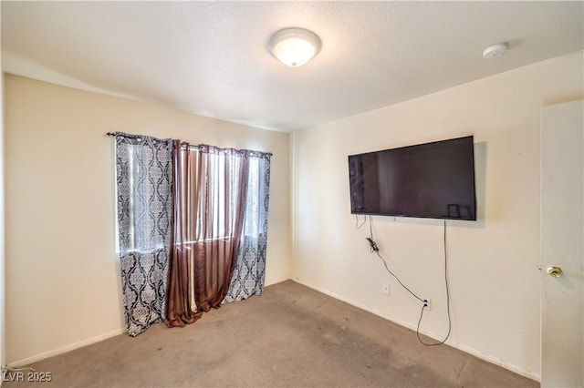 carpeted spare room featuring a textured ceiling