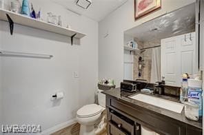 bathroom with a shower with curtain, vanity, and toilet