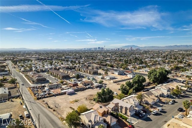 birds eye view of property featuring a view of city, a mountain view, and a residential view