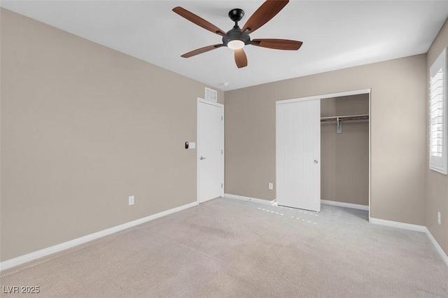 unfurnished bedroom with ceiling fan, light colored carpet, and a closet