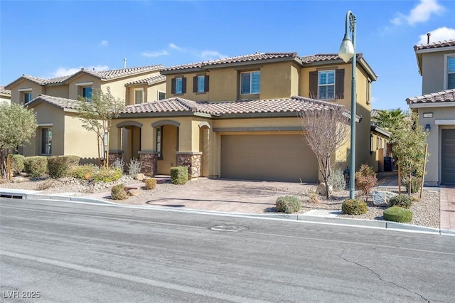 mediterranean / spanish house with a garage