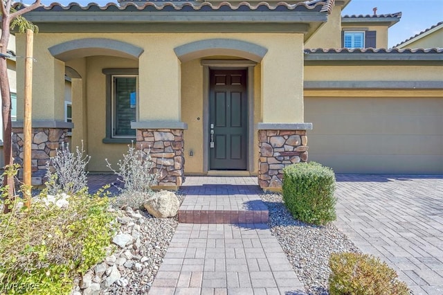 view of exterior entry with a garage