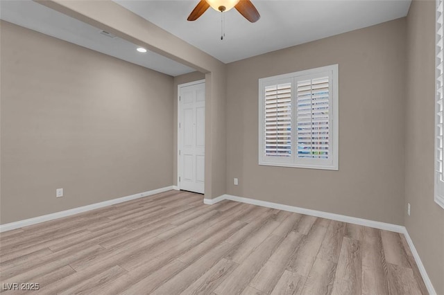 unfurnished room with ceiling fan and light hardwood / wood-style flooring