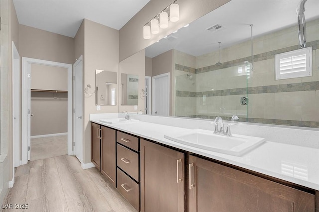 bathroom with vanity and a shower with shower door