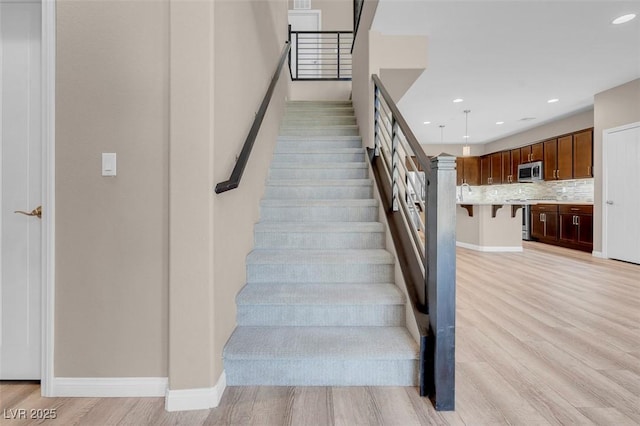 stairs with hardwood / wood-style floors