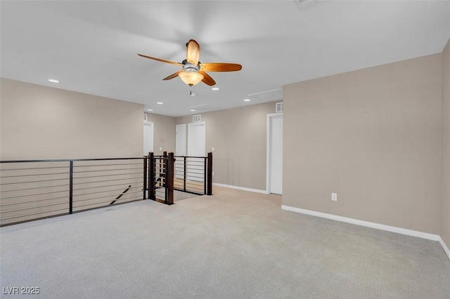 carpeted spare room featuring ceiling fan