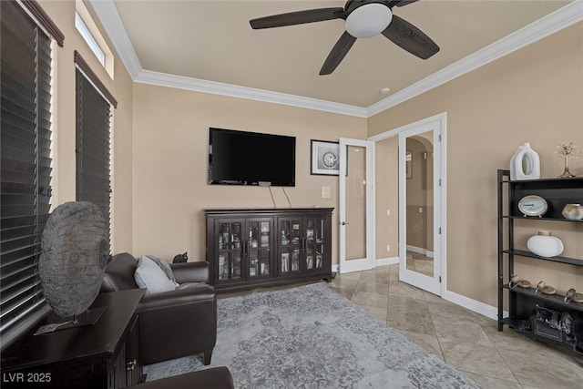 tiled living room with crown molding, ceiling fan, and french doors