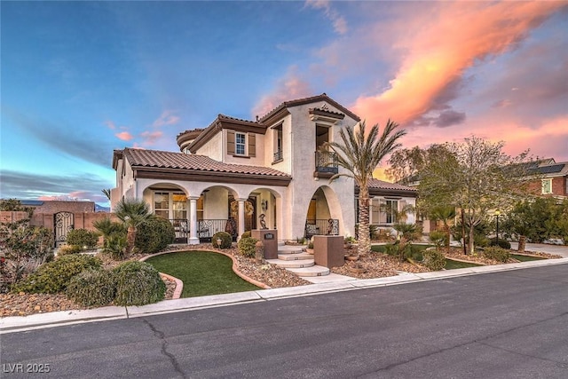 mediterranean / spanish home with covered porch