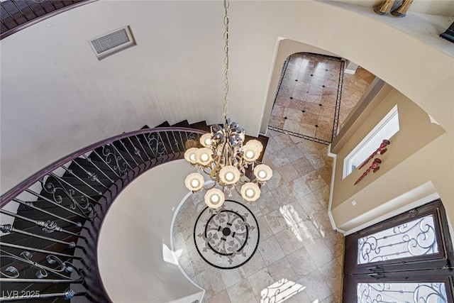 stairway featuring an inviting chandelier