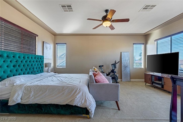 carpeted bedroom featuring multiple windows and ceiling fan