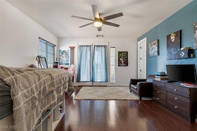 bedroom with dark hardwood / wood-style floors and ceiling fan