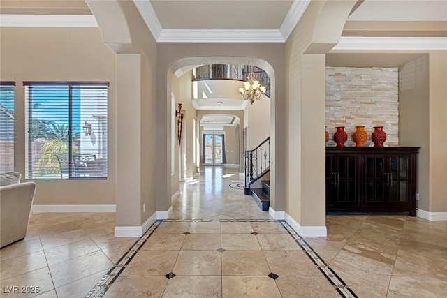 tiled entryway featuring crown molding