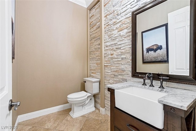 bathroom with tile patterned flooring, vanity, and toilet