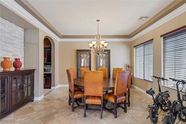 dining room featuring ornamental molding and a chandelier