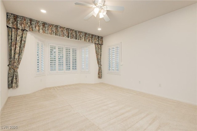 carpeted empty room featuring ceiling fan