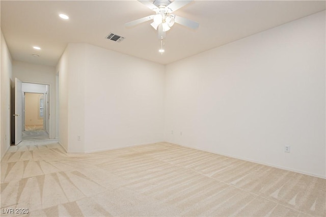 carpeted spare room with ceiling fan