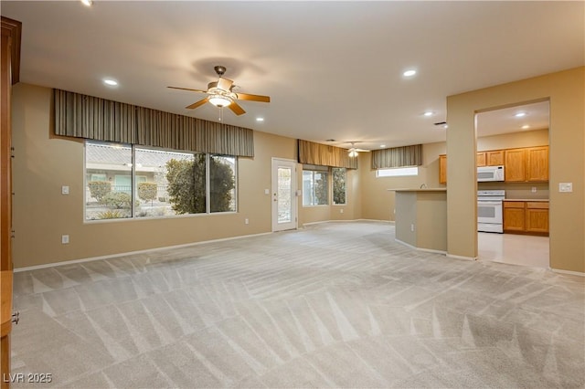 unfurnished living room with light carpet and ceiling fan