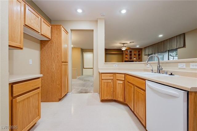 kitchen featuring ceiling fan, sink, and white dishwasher