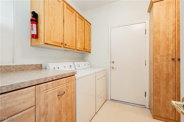 laundry area featuring cabinets and washer and dryer