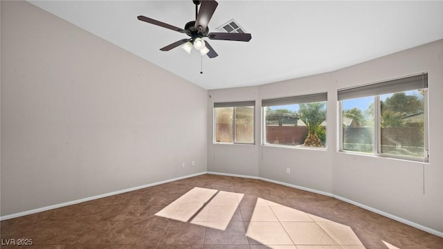 spare room featuring lofted ceiling, tile patterned floors, and ceiling fan